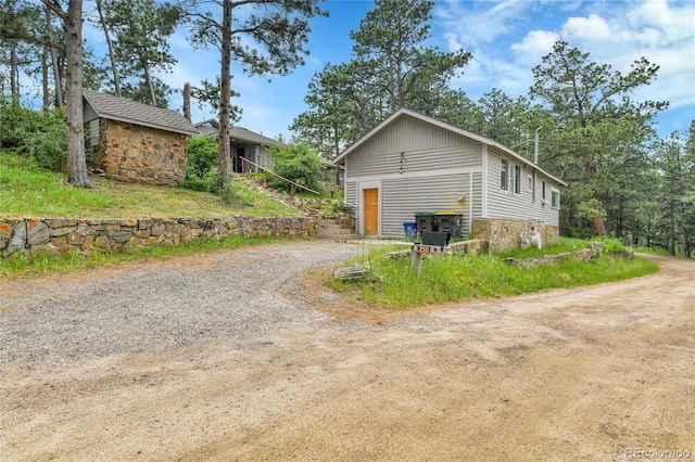 350 Tower Hill Cir, Golden, CO 80401 - view of side of home with stone siding and dirt driveway