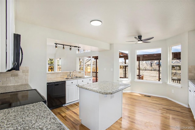 kitchen featuring white cabinetry, dishwasher, ceiling fan, light hardwood / wood-style flooring, and backsplash