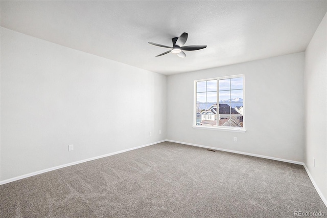 carpeted empty room with ceiling fan