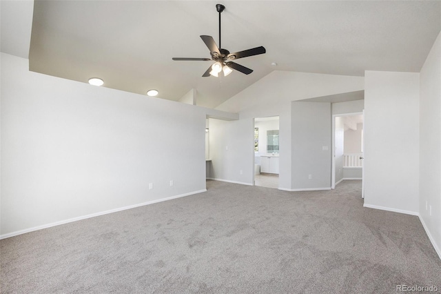 unfurnished living room featuring carpet floors, vaulted ceiling, and ceiling fan