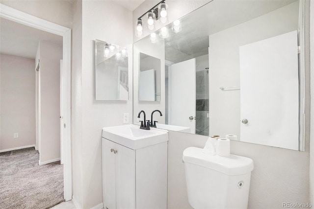 bathroom featuring vanity, toilet, and a shower with door