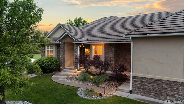 5653 Yank St, Arvada, CO 80002 - property entrance featuring stone siding, stucco siding, and a tile roof