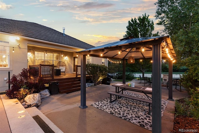 5653 Yank St, Arvada, CO 80002 - patio terrace at dusk featuring a gazebo, a patio, and a deck