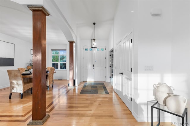 5653 Yank St, Arvada, CO 80002 - entryway featuring decorative columns, light wood-style floors, arched walkways, and baseboards