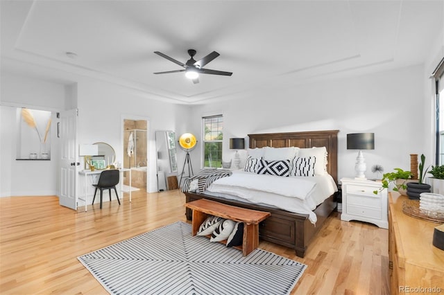 5653 Yank St, Arvada, CO 80002 - bedroom with light wood finished floors, ensuite bathroom, and ceiling fan