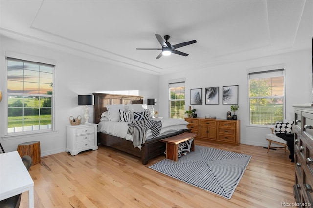 5653 Yank St, Arvada, CO 80002 - bedroom with light wood-style flooring, multiple windows, baseboards, and a ceiling fan