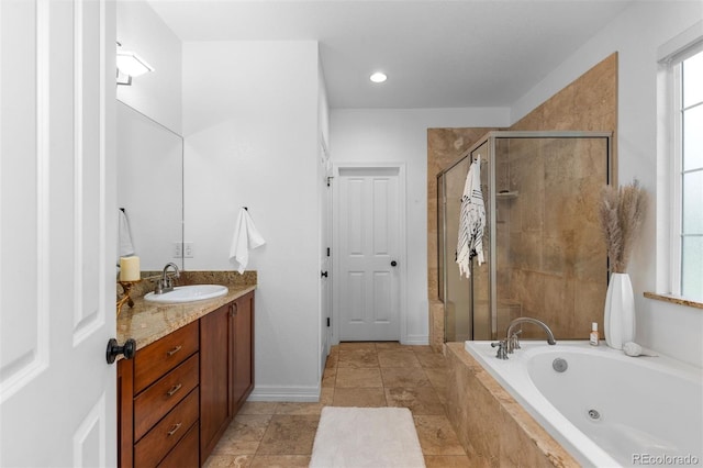 5653 Yank St, Arvada, CO 80002 - bathroom featuring a tub with jets, a shower stall, vanity, baseboards, and recessed lighting