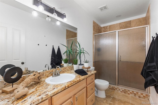 5653 Yank St, Arvada, CO 80002 - full bathroom with vanity, a stall shower, and toilet