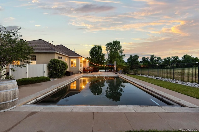 5653 Yank St, Arvada, CO 80002 - pool at dusk featuring a patio area