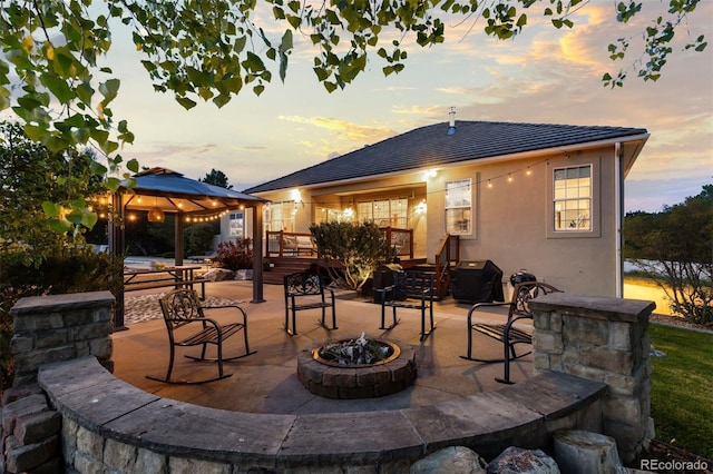 5653 Yank St, Arvada, CO 80002 - view of patio featuring an outdoor fire pit, a gazebo, a wooden deck, and a grill