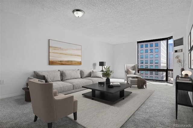 carpeted living room featuring floor to ceiling windows and a textured ceiling