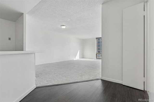 interior space featuring dark hardwood / wood-style flooring and a textured ceiling