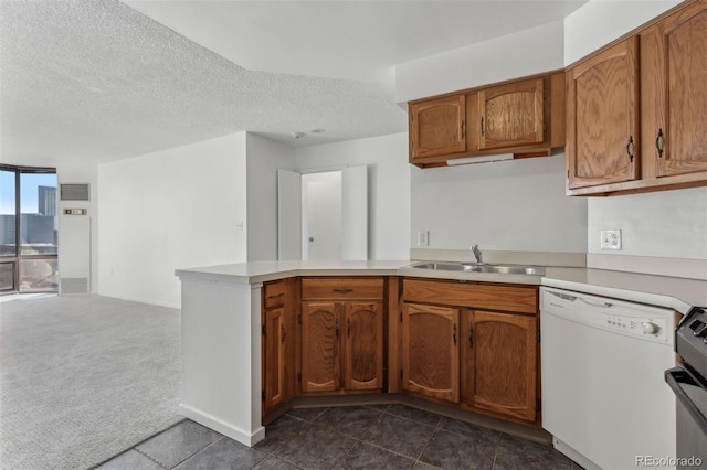 kitchen with sink, dark colored carpet, white dishwasher, kitchen peninsula, and a textured ceiling