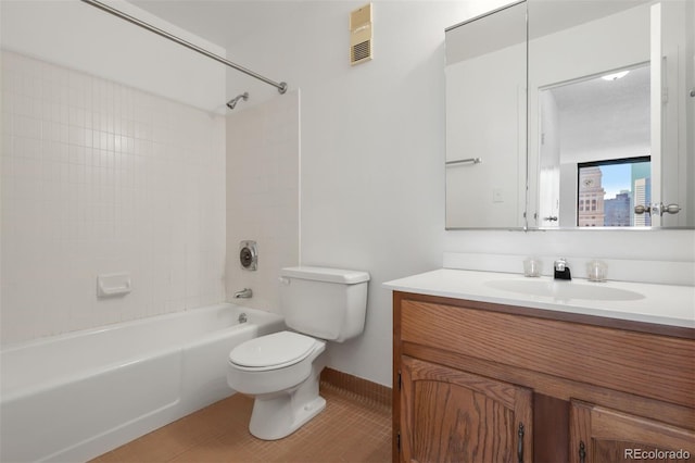 full bathroom with tile patterned flooring, tiled shower / bath, vanity, and toilet