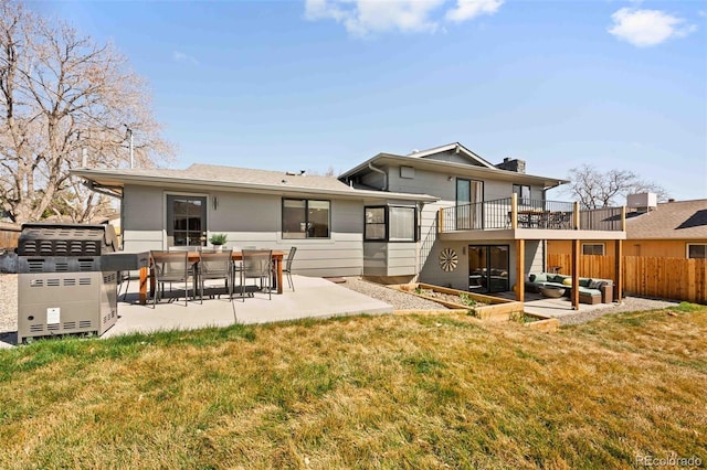 6844 W 69th Pl, Arvada, CO 80003 - back of property with outdoor lounge area, a patio area, a balcony, and a chimney