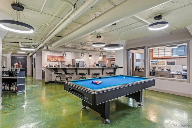 playroom featuring pool table, bar area, and concrete floors