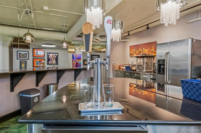 kitchen featuring stainless steel refrigerator with ice dispenser