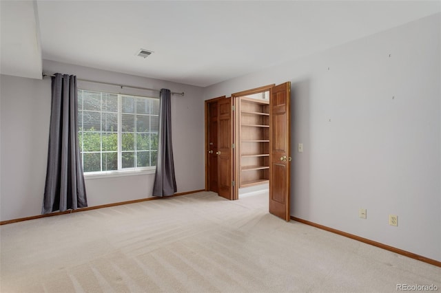 3951 S Carson St Unit D, Aurora, CO 80014 - unfurnished bedroom with baseboards, light colored carpet, and a closet