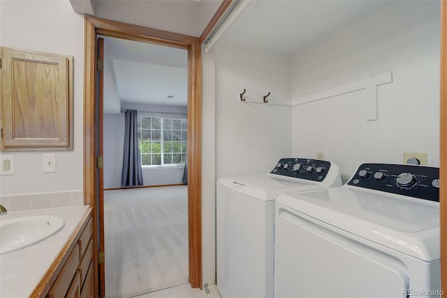 3951 S Carson St Unit D, Aurora, CO 80014 - washroom with washing machine and clothes dryer, a sink, and light colored carpet