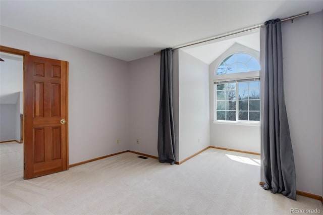 3951 S Carson St Unit D, Aurora, CO 80014 - unfurnished room featuring light carpet, vaulted ceiling, and baseboards