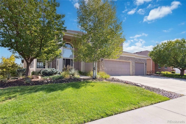 view of property hidden behind natural elements featuring a garage and a front lawn