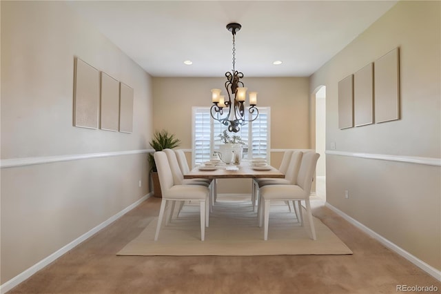 unfurnished dining area featuring a chandelier and light colored carpet