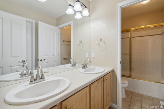 full bathroom with tile patterned floors, shower / bath combination with glass door, toilet, and vanity