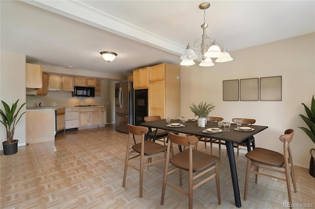 dining room with light parquet floors and a chandelier