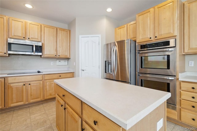 kitchen featuring a kitchen island, stainless steel appliances, and light brown cabinetry