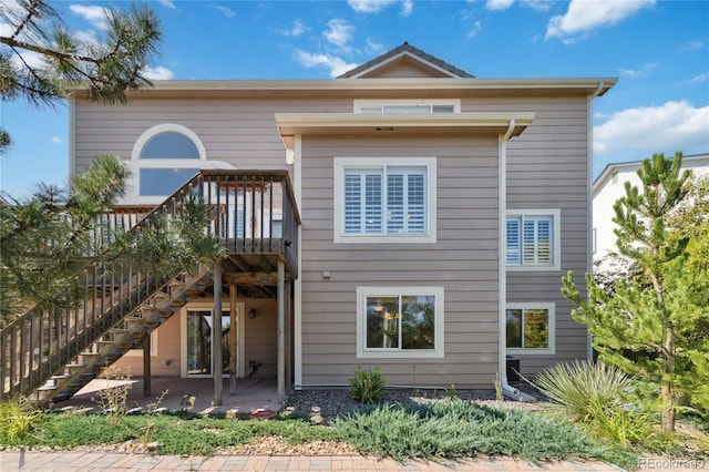 rear view of house featuring a patio area and a deck