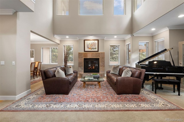 carpeted living room featuring a fireplace, plenty of natural light, and crown molding