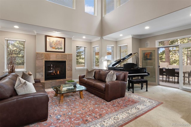 living room with carpet flooring, ornamental molding, and a tile fireplace