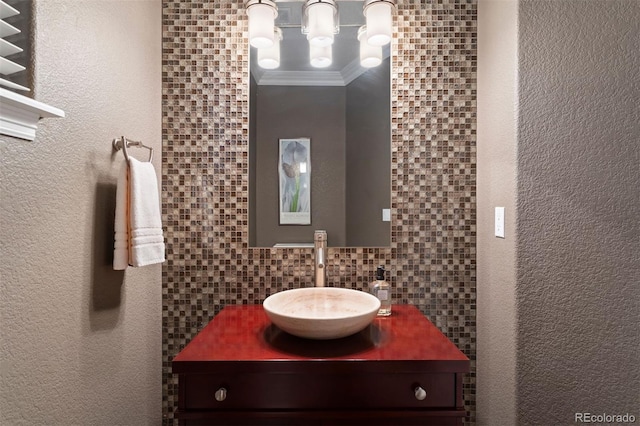 bathroom with vanity, backsplash, and ornamental molding