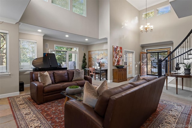 living room with crown molding, a towering ceiling, and an inviting chandelier