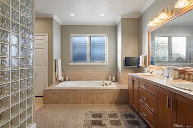 bathroom featuring vanity, a relaxing tiled tub, and ornamental molding