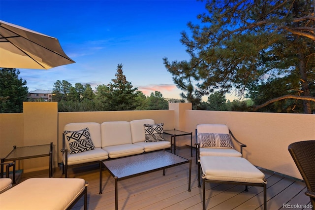 deck at dusk with an outdoor living space