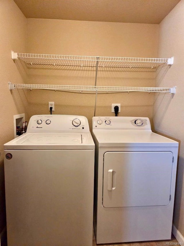 clothes washing area featuring laundry area and washing machine and clothes dryer