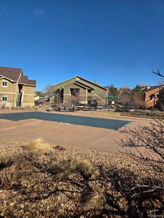 view of front of house with fence and playground community