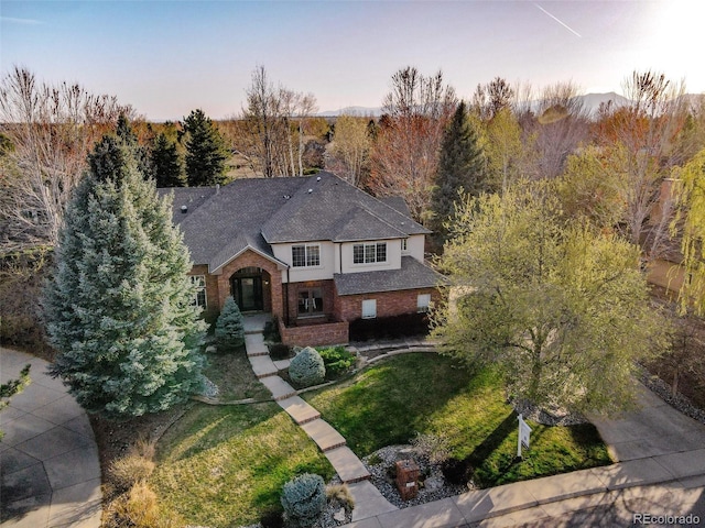 2464 Ginny Way, Lafayette, CO 80026 - traditional home with brick siding, a front lawn, and a shingled roof