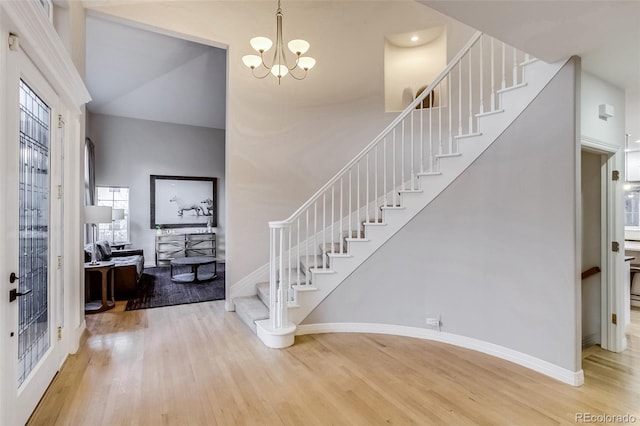 2464 Ginny Way, Lafayette, CO 80026 - foyer featuring wood finished floors, stairs, a chandelier, and baseboards