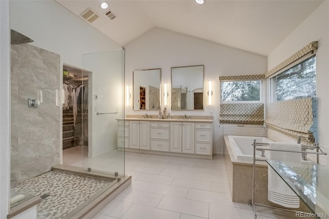 2464 Ginny Way, Lafayette, CO 80026 - full bath with double vanity, a stall shower, a bath, vaulted ceiling, and tile patterned floors