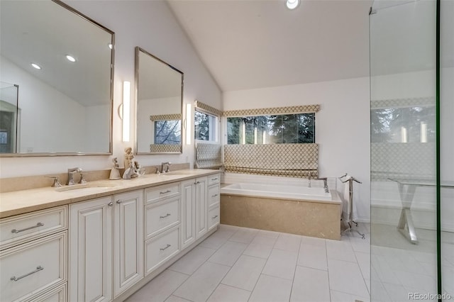 2464 Ginny Way, Lafayette, CO 80026 - bathroom with vaulted ceiling, a bath, double vanity, tile patterned flooring, and recessed lighting