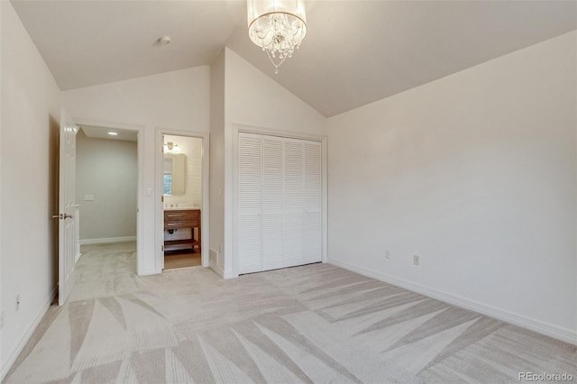 2464 Ginny Way, Lafayette, CO 80026 - unfurnished bedroom with light colored carpet, baseboards, a chandelier, a closet, and lofted ceiling