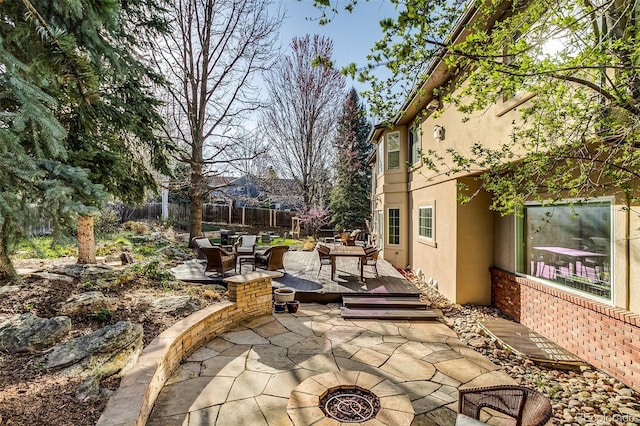 2464 Ginny Way, Lafayette, CO 80026 - view of patio / terrace featuring a deck, outdoor dining area, and a fire pit