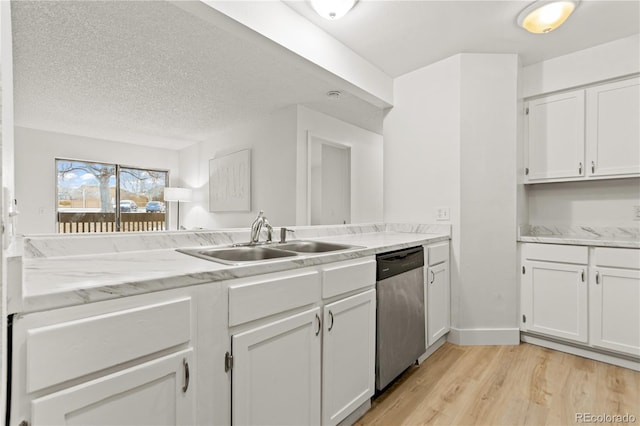 kitchen with white cabinetry, sink, stainless steel dishwasher, and light wood-type flooring