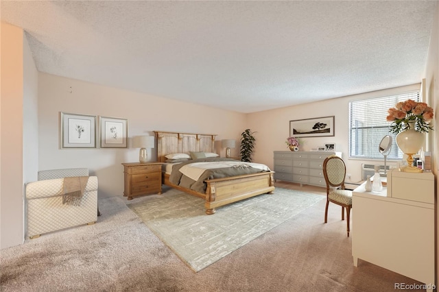 carpeted bedroom with a textured ceiling and a wall unit AC