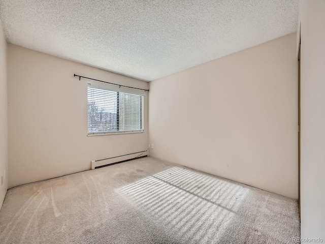 carpeted spare room featuring a textured ceiling and baseboard heating