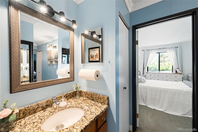 7780 W 38th Ave Unit 203, Wheat Ridge, CO 80033 - bathroom with ornamental molding, ensuite bath, vanity, and toilet