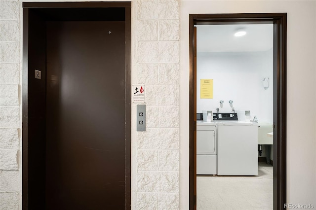 7780 W 38th Ave Unit 203, Wheat Ridge, CO 80033 - laundry area featuring elevator and washing machine and clothes dryer