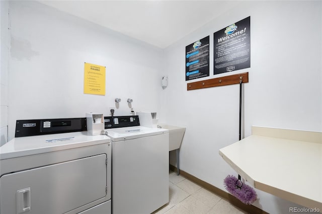 7780 W 38th Ave Unit 203, Wheat Ridge, CO 80033 - shared laundry room featuring washer and clothes dryer and baseboards